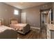 Cozy bedroom with two twin beds, and neutral walls with hardwood floors at 14205 Falls Church Dr # 2012, Orlando, FL 32837