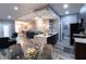 Open-concept dining area with elegant lighting, a modern island, and sleek furnishings, ideal for entertaining at 14205 Falls Church Dr # 2012, Orlando, FL 32837