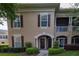 Charming townhome showcasing a private balcony and beautifully landscaped front entrance with green lawn at 14205 Falls Church Dr # 2012, Orlando, FL 32837