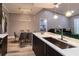 Bright open kitchen with a modern island, elegant lighting, and views into the living and dining areas, ideal for gatherings at 14205 Falls Church Dr # 2012, Orlando, FL 32837