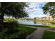 Beautiful pond view with a fountain surrounded by lush greenery and manicured landscaping at 14205 Falls Church Dr # 2012, Orlando, FL 32837