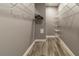 Walk-in closet with white wire shelving and hardwood floors perfect for organizing and storing clothes at 14205 Falls Church Dr # 2012, Orlando, FL 32837