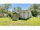 Rear exterior showcasing siding, backyard shed for storage, and a well-maintained lawn at 1431 Jack Calhoun Dr, Kissimmee, FL 34741