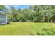Spacious backyard with lush green grass, mature trees, and a privacy fence, providing a serene outdoor retreat at 1431 Jack Calhoun Dr, Kissimmee, FL 34741