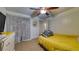 Bedroom featuring a ceiling fan and a view of the hallway, providing a calming space for relaxation at 1431 Jack Calhoun Dr, Kissimmee, FL 34741