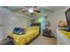 Bedroom featuring a ceiling fan and bright curtains, offering a calming space for relaxation at 1431 Jack Calhoun Dr, Kissimmee, FL 34741