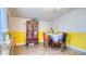 The dining room features a decorative curio cabinet, colorful walls, and bar seating at 1431 Jack Calhoun Dr, Kissimmee, FL 34741