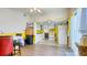 View of the dining and kitchen area featuring an open floor plan, bright yellow walls, and plenty of natural light at 1431 Jack Calhoun Dr, Kissimmee, FL 34741