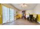 The dining area is awash with natural light from a large sliding glass door, and a table is adorned with flowers at 1431 Jack Calhoun Dr, Kissimmee, FL 34741