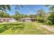 Charming single-story home with a well-maintained lawn and mature shade trees at 1431 Jack Calhoun Dr, Kissimmee, FL 34741