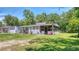 Charming single-story home with a well-maintained lawn and inviting porch seating at 1431 Jack Calhoun Dr, Kissimmee, FL 34741