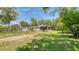 Single-story home with a well-maintained lawn, mature shade trees, and inviting porch seating at 1431 Jack Calhoun Dr, Kissimmee, FL 34741
