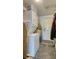 A functional laundry room is equipped with a stacked washer and dryer, and ample storage space at 1431 Jack Calhoun Dr, Kissimmee, FL 34741