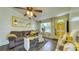 Comfortable living room with laminate flooring, ceiling fan, a brightly painted front door, and neutral color furniture at 1431 Jack Calhoun Dr, Kissimmee, FL 34741