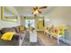 Comfortable living room with laminate flooring, a ceiling fan and a brightly painted front door at 1431 Jack Calhoun Dr, Kissimmee, FL 34741