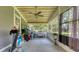 Enclosed patio featuring a ceiling fan and outdoor access, creating an adaptable space for relaxation and recreation at 1431 Jack Calhoun Dr, Kissimmee, FL 34741
