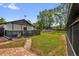 This backyard has a partially covered porch and a well-maintained lawn at 1501 Missouri Ave, St Cloud, FL 34769