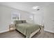 Bedroom with hardwood floors, green bedding, neutral walls, and natural lighting at 1501 Missouri Ave, St Cloud, FL 34769