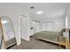 Bright bedroom with hardwood floors, sliding closet doors and minimalist decor at 1501 Missouri Ave, St Cloud, FL 34769
