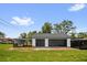 Detached two-car garage featuring black garage doors with a covered carport at 1501 Missouri Ave, St Cloud, FL 34769