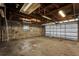 Spacious garage featuring concrete block walls, open ceiling with lights and an updated garage door at 1501 Missouri Ave, St Cloud, FL 34769