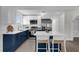 Modern kitchen with stainless steel appliances, a breakfast bar, and white shaker cabinets at 1501 Missouri Ave, St Cloud, FL 34769
