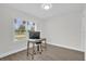 Home office features a minimalist desk, rolling chair and light hardwood flooring at 1501 Missouri Ave, St Cloud, FL 34769