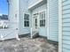 Quaint backyard patio with brick pavers, light blue exterior, and white trim at 1513 Resolute St, Celebration, FL 34747
