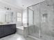 Bathroom featuring dual sinks, vanity, soaking tub, a large glass enclosed shower with custom tile, and natural light at 1513 Resolute St, Celebration, FL 34747