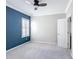 A bedroom features a door, a window with shutters, plush carpet and a ceiling fan at 1513 Resolute St, Celebration, FL 34747