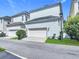 Exterior shows the garage of a light-blue two-story home at 1513 Resolute St, Celebration, FL 34747