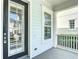 Close-up of front door, decorative sidelight window, exterior paint and architectural trim on the front porch at 1513 Resolute St, Celebration, FL 34747