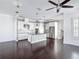 Open-concept kitchen with sleek stainless-steel appliances, granite countertops, and dark hardwood floors in adjacent space at 1513 Resolute St, Celebration, FL 34747
