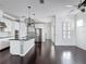 Bright, open kitchen featuring stainless steel appliances, white cabinetry, and a center island with pendant lighting at 1513 Resolute St, Celebration, FL 34747