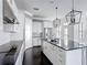 Beautiful kitchen with granite counters, stainless steel appliances, an island with sink and pendant lights, and white cabinets at 1513 Resolute St, Celebration, FL 34747