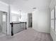 Upstairs landing area with plush carpeting, a decorative chandelier, and views to the outside through shuttered windows at 1513 Resolute St, Celebration, FL 34747