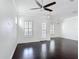 Spacious living room with hardwood flooring, neutral color palette, and ample natural light through shuttered windows at 1513 Resolute St, Celebration, FL 34747