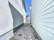 Wide view of side yard showing a brick-paved pathway between houses and a white gate at 1513 Resolute St, Celebration, FL 34747