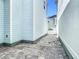 View of side yard, showing the brick-paved pathway between houses and a white gate at 1513 Resolute St, Celebration, FL 34747