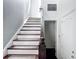 This home features a carpeted staircase with decorative wood handrails and white risers leading to the upper level at 1513 Resolute St, Celebration, FL 34747
