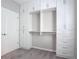 A walk-in closet features built-in white shelving, drawers, and carpet flooring at 1513 Resolute St, Celebration, FL 34747