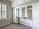 A walk-in closet offers custom white shelving units with drawers and carpeted floor at 1513 Resolute St, Celebration, FL 34747
