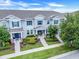 Attractive townhome showing well maintained landscaping, sidewalks, and inviting front entrances at 15540 Blackbead St, Winter Garden, FL 34787