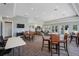 Spacious amenity room with tables, chairs, and a lounge area for residents to gather at 15540 Blackbead St, Winter Garden, FL 34787