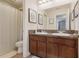 Well-lit bathroom features double sinks, a dark wood vanity, and a shower/tub combination at 15540 Blackbead St, Winter Garden, FL 34787