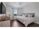 Bright bedroom features hardwood floors, neutral walls, and a comfortable queen-size bed with soft pillows at 15540 Blackbead St, Winter Garden, FL 34787