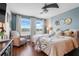 Bright bedroom featuring a plush bed, ceiling fan, and lots of natural light at 15540 Blackbead St, Winter Garden, FL 34787