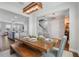 Dining area featuring a rustic table, and sightlines into the open floor plan and kitchen at 15540 Blackbead St, Winter Garden, FL 34787