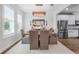 Dining area with a stylish chandelier, designer furniture, and lots of natural light at 15540 Blackbead St, Winter Garden, FL 34787
