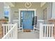 Welcoming porch with rocking chairs, charming decor, and attractive blue front door at 15540 Blackbead St, Winter Garden, FL 34787